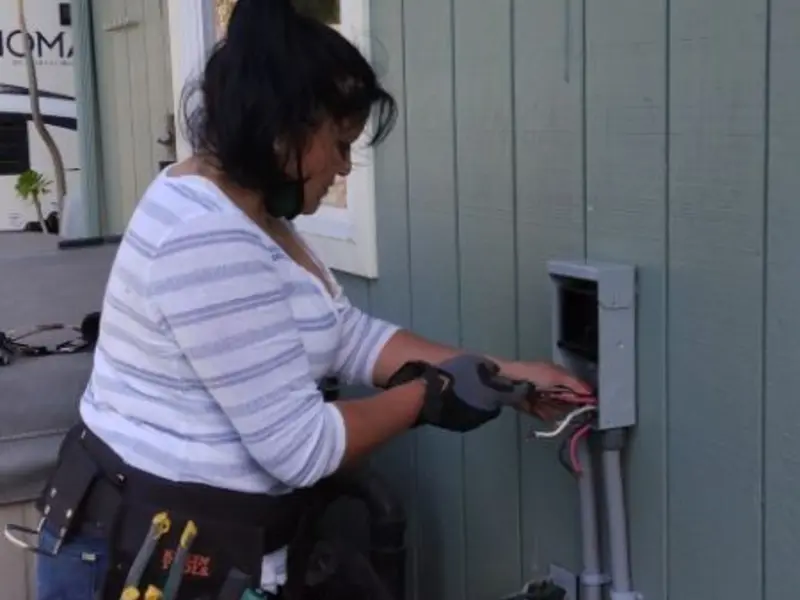 Licensed electrician wiring an exterior subpanel in Calera